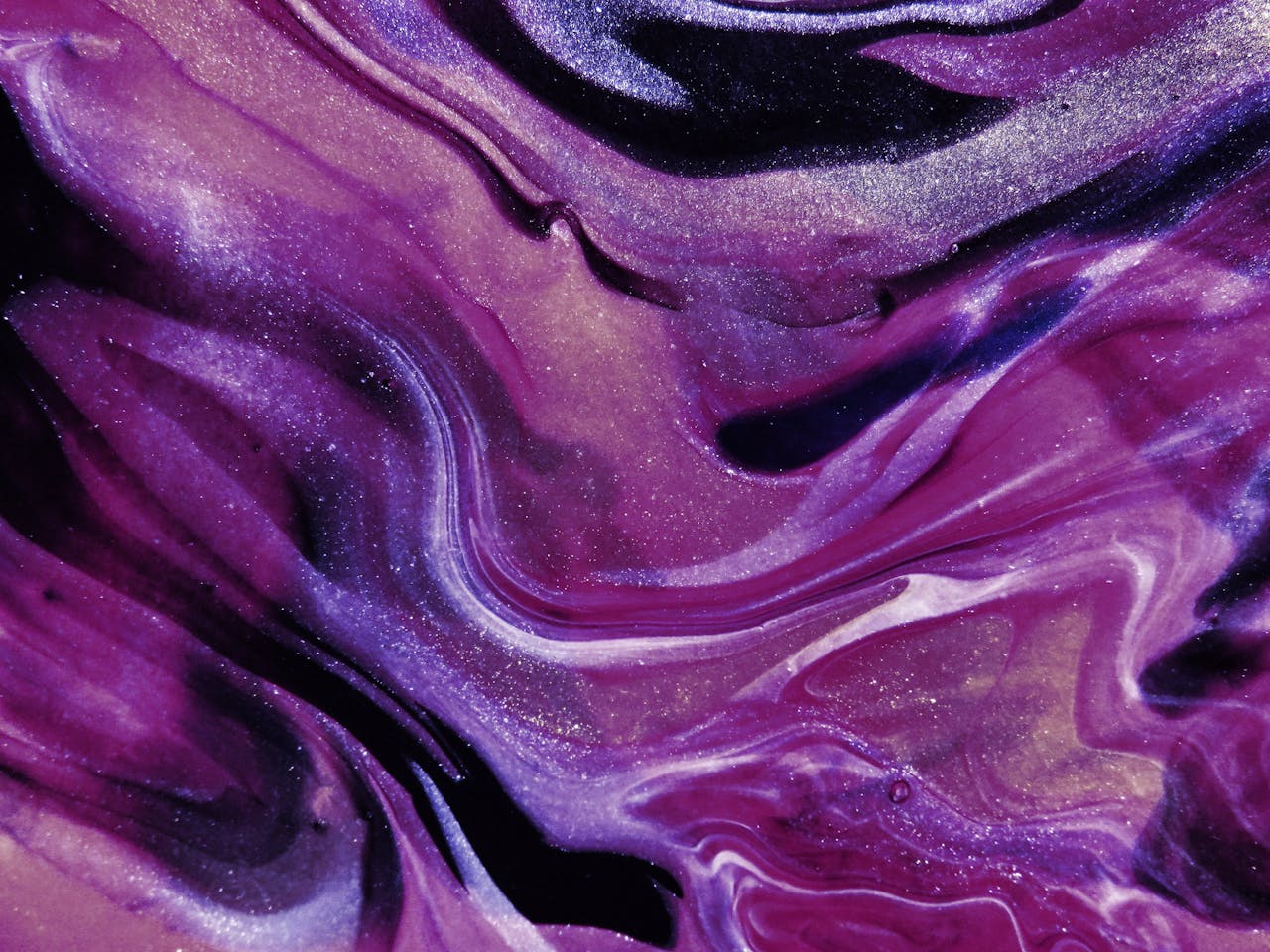 Glittery abstract art with vibrant purple and lilac swirls, perfect for creative projects.